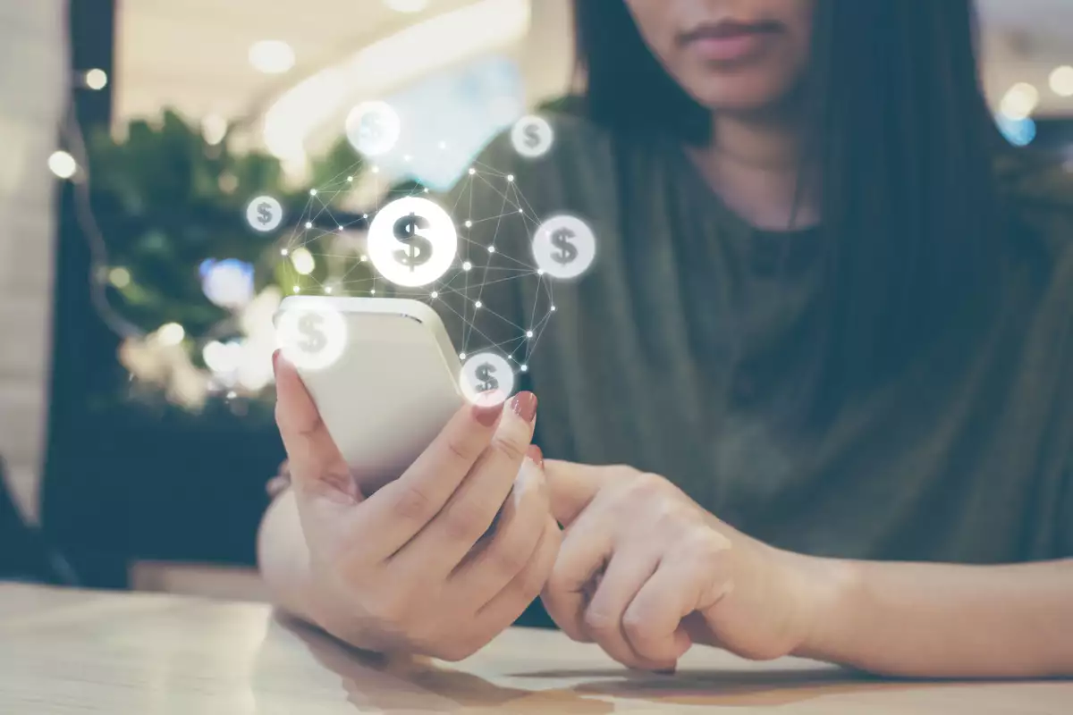 online banking. Shocked man using smartphone dollar bills flying away