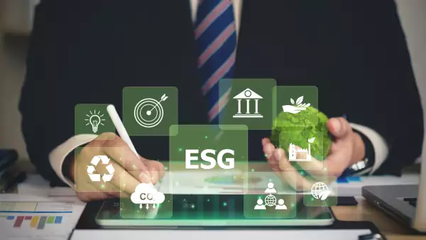 ESG environment social governance investment business concept. Businessmen use a computer to analyze ESG, surrounded by ESG icons close to the computer screen in business investment strategy concept.