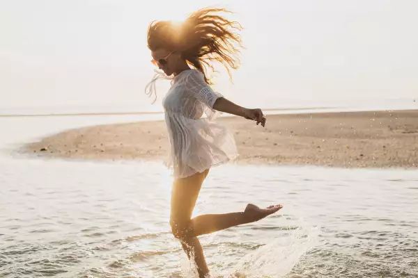 Young,Slim,Beautiful,Woman,On,Sunset,Beach,,Playful,,Dancing,,Running,