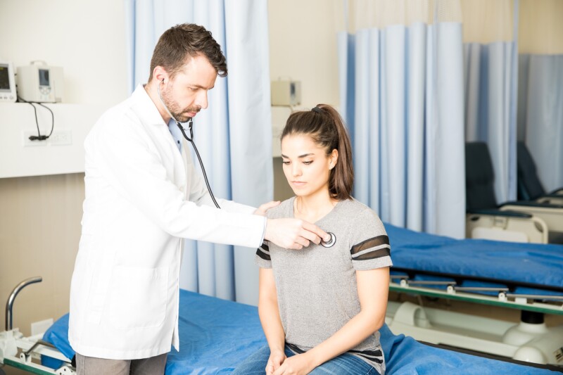 Doctor examining female patient