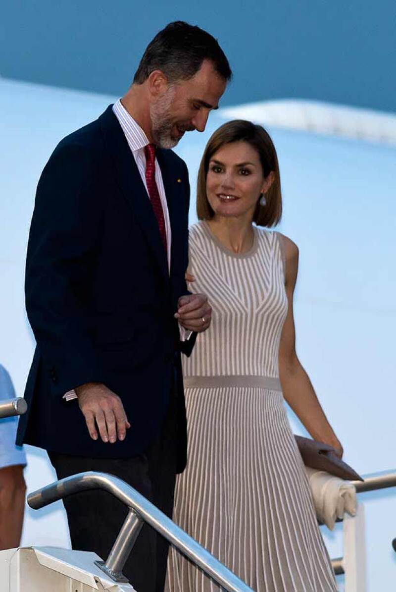 Felipe VI, ataviado con un traje oscuro, y Letizia, con un vestido sin mangas de tonos neutros.