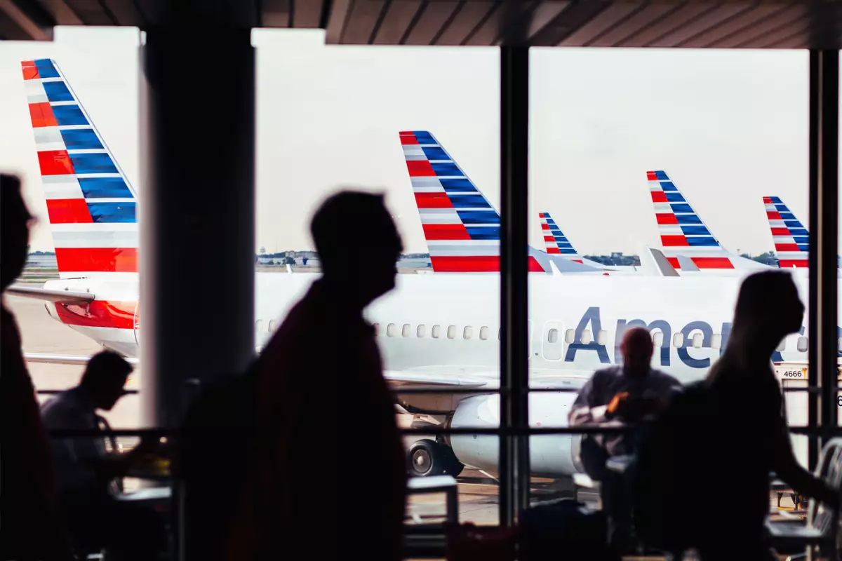 American Airlines fleet of airplanes with passengers at O'Hare Airport