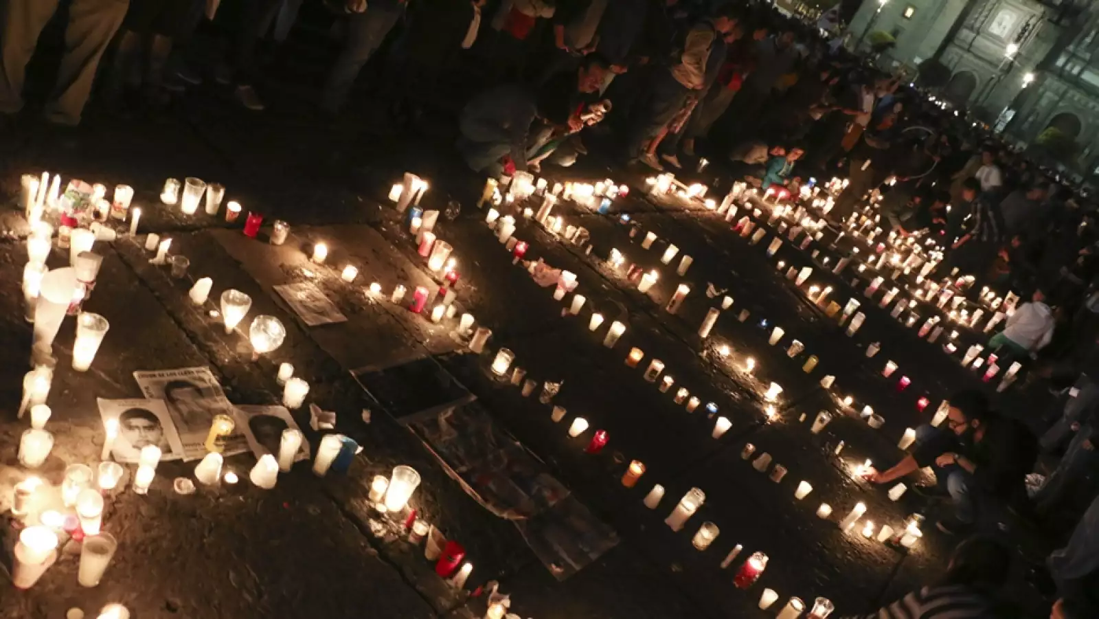 Frente a Bellas Artes, personas encienden velas