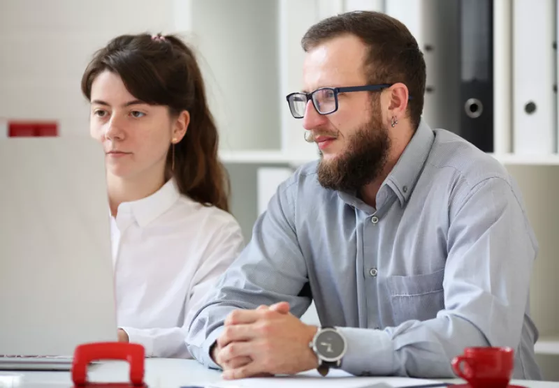 Man and woman teamwork in the office. Look at the computer monitor
