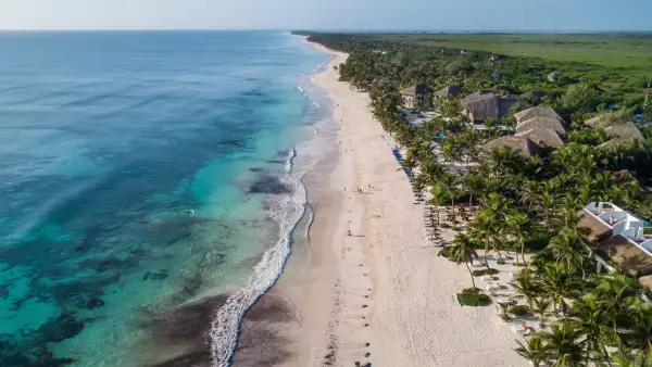 Top view aerial photo from flying drone of an amazingly beautiful sea landscape. Sea Aerial view, Top view. Tulum Beach, Mexico. Sea Aerial view. Amazing nature background. The color of the water and beautifully bright. Azure beach.