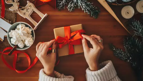 Woman wrapping Christmas gifts, overhead shot