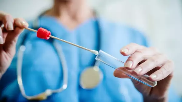 Close up of doctor with sample from sick woman. Selective focus on sample.