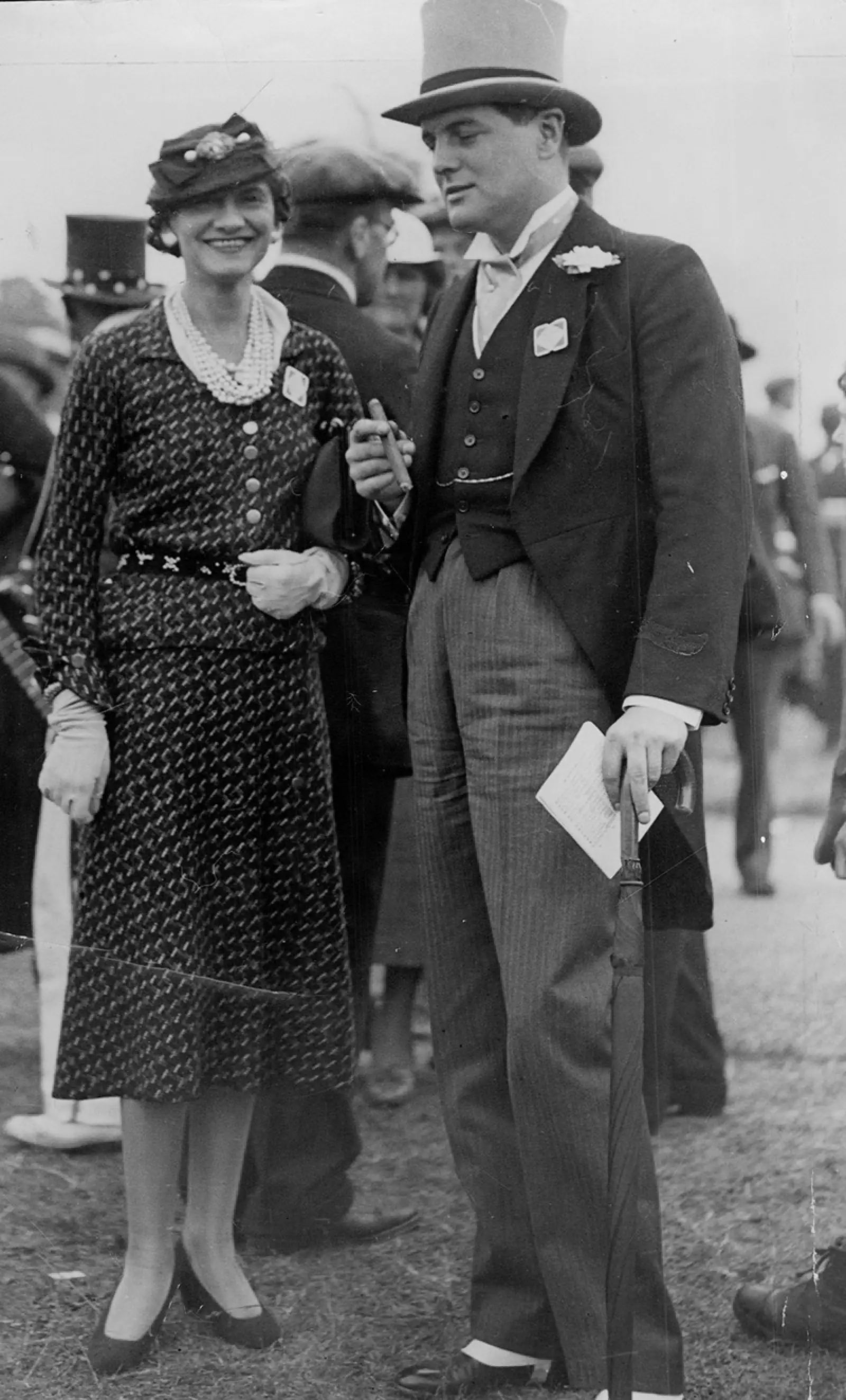 Politician Randolph Churchill With Fashion Designer Coco Chanel At Ascot Randolph Frederick Edward Spencer-churchill Mbe (28 May 1911 A 6 June 1968) Was The Son Of British Prime Minister Winston Churchill And His Wife Clementine. He Was A Conservativ