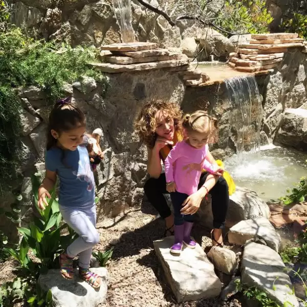 La empresaria con sus hijas, de paseo en un parque.
