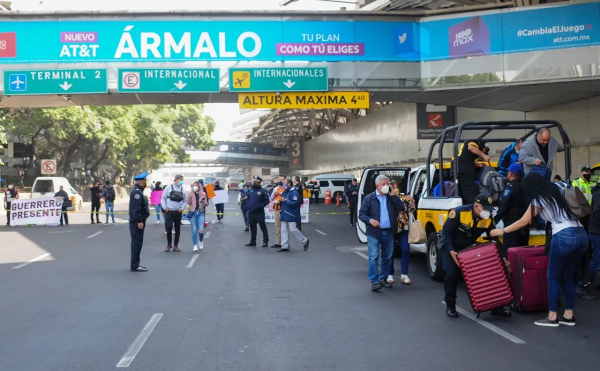 Turistas son apoyados ante el bloqueo en la T1 del AICM.