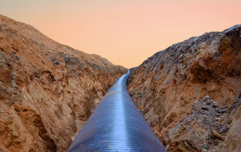 Constructing pipelines that transport oil, natural gas, petroleum and crude production. A dug trench in the ground for the installation of industrial gas and crude pipes