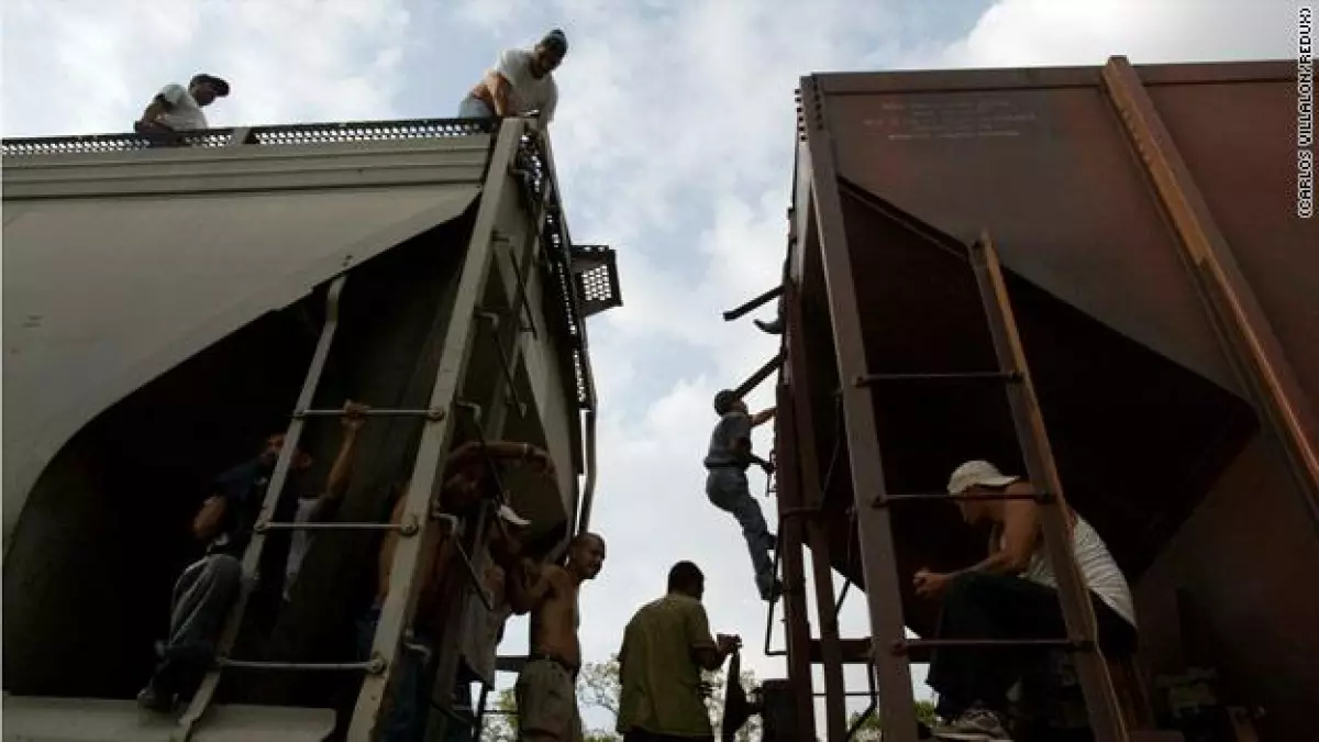 Inmigrantes ilegales suben al tren durante una breve parada en la localidad de Chaguites, México.