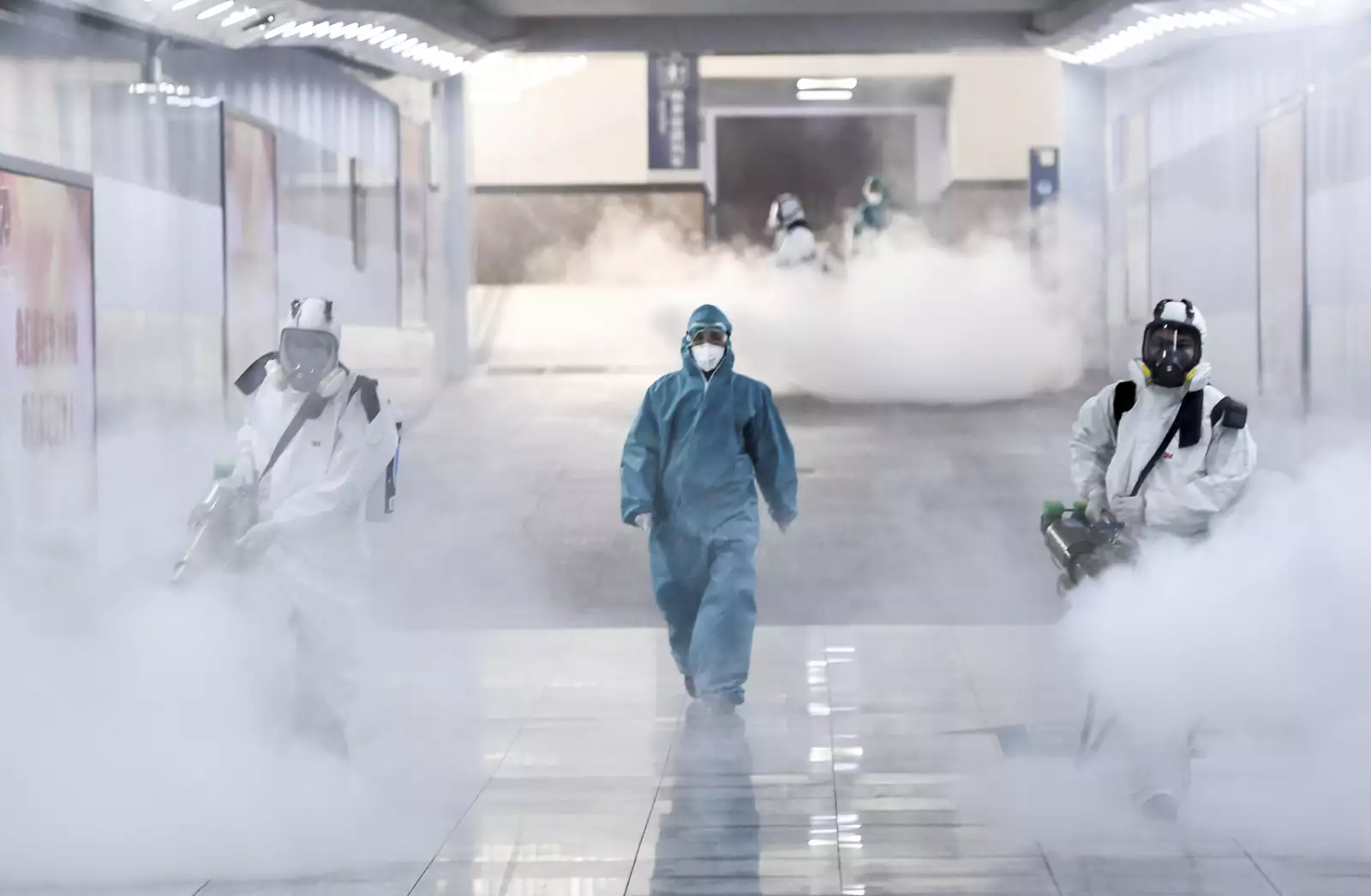 Volunteers in protective suits disinfect a railway station as the country is hit by an outbreak of the new coronavirus, in Changsha