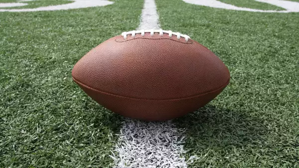 Ground level view of a football on the fifty yard line