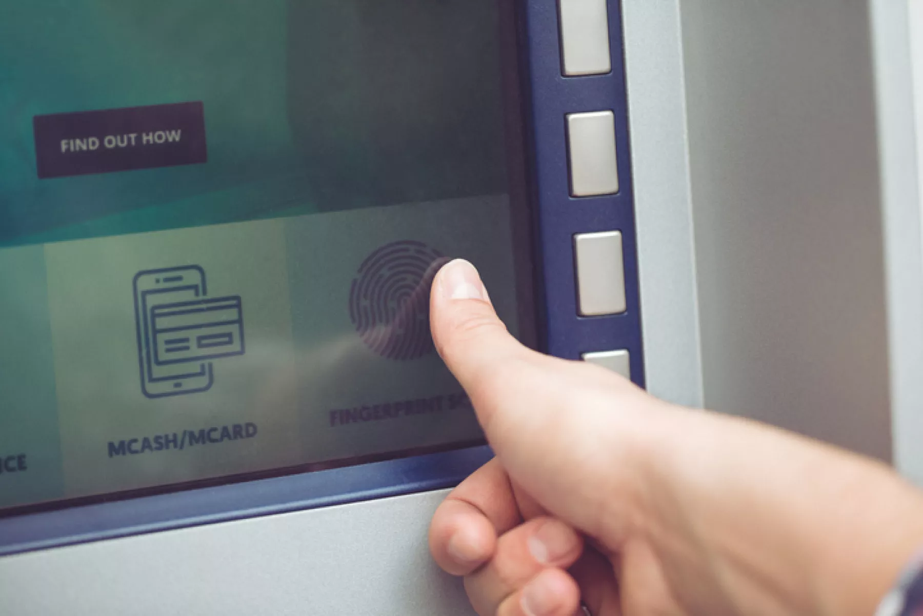 Woman at ATM using fingerprint recognition technology