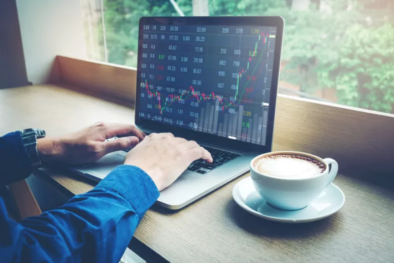 Business man working Laptop Stock market exchange information and Trading graph