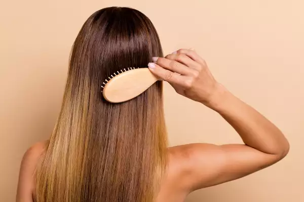 Rear,Back,Behind,View,Portrait,Of,Attractive,Woman,Combing,Smooth