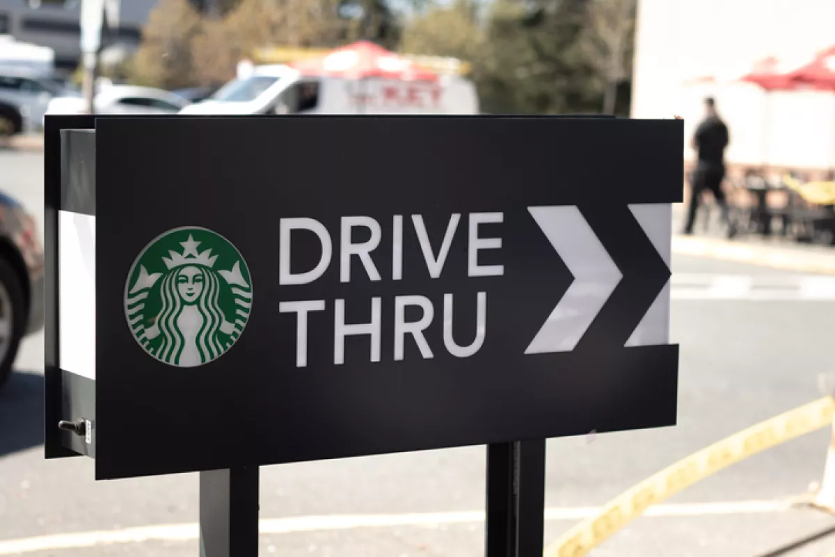 Cars lining up to order food using drive-thru facilitiy at local Starbucks Coffee Shop