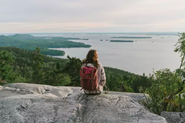 Scenic view of woman looking at lake in Finland