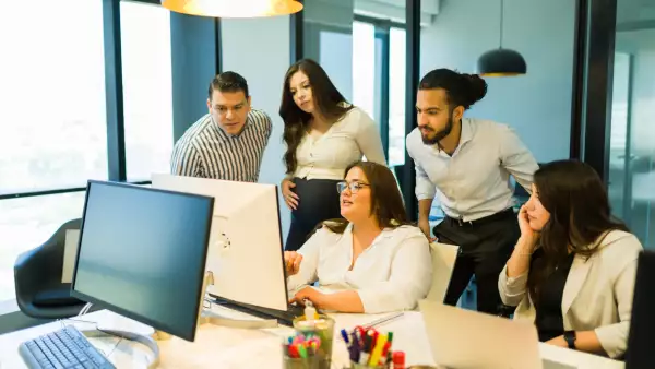 Plus size businesswoman sharing project details with team in office