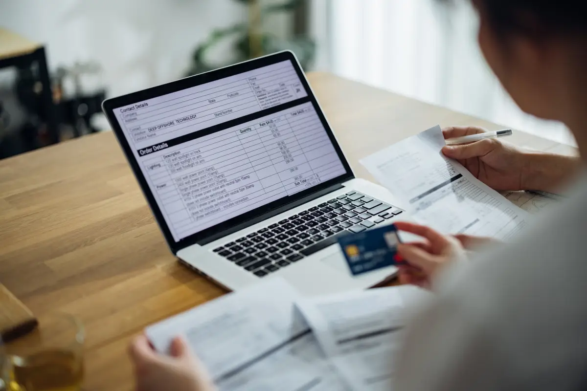 Unrecognizable Couple Paying Bills at Home