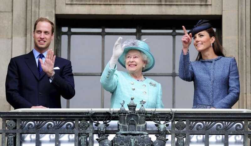 Aquí Guillermo, Isabel II y Kate saludando a los presentes desde el balcón.