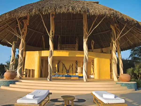 Esta palapa está sostenida por troncos de palmeras. En el segundo piso se encuentra el comedor. Este estilo de construcción predomina en las casas de Careyes.