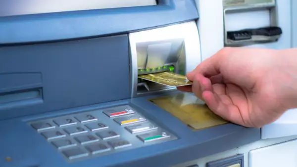 Hand inserting ATM credit card