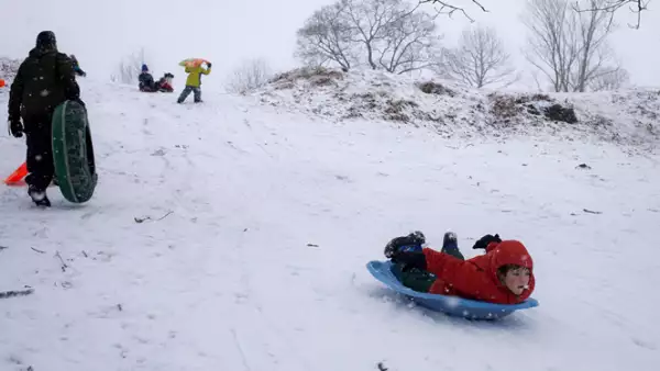 Reportes meteorológicos indican que esta podría ser la peor tormenta de nieve hasta ahora registrada. Un niño se desliza por una colina en Nueva York.