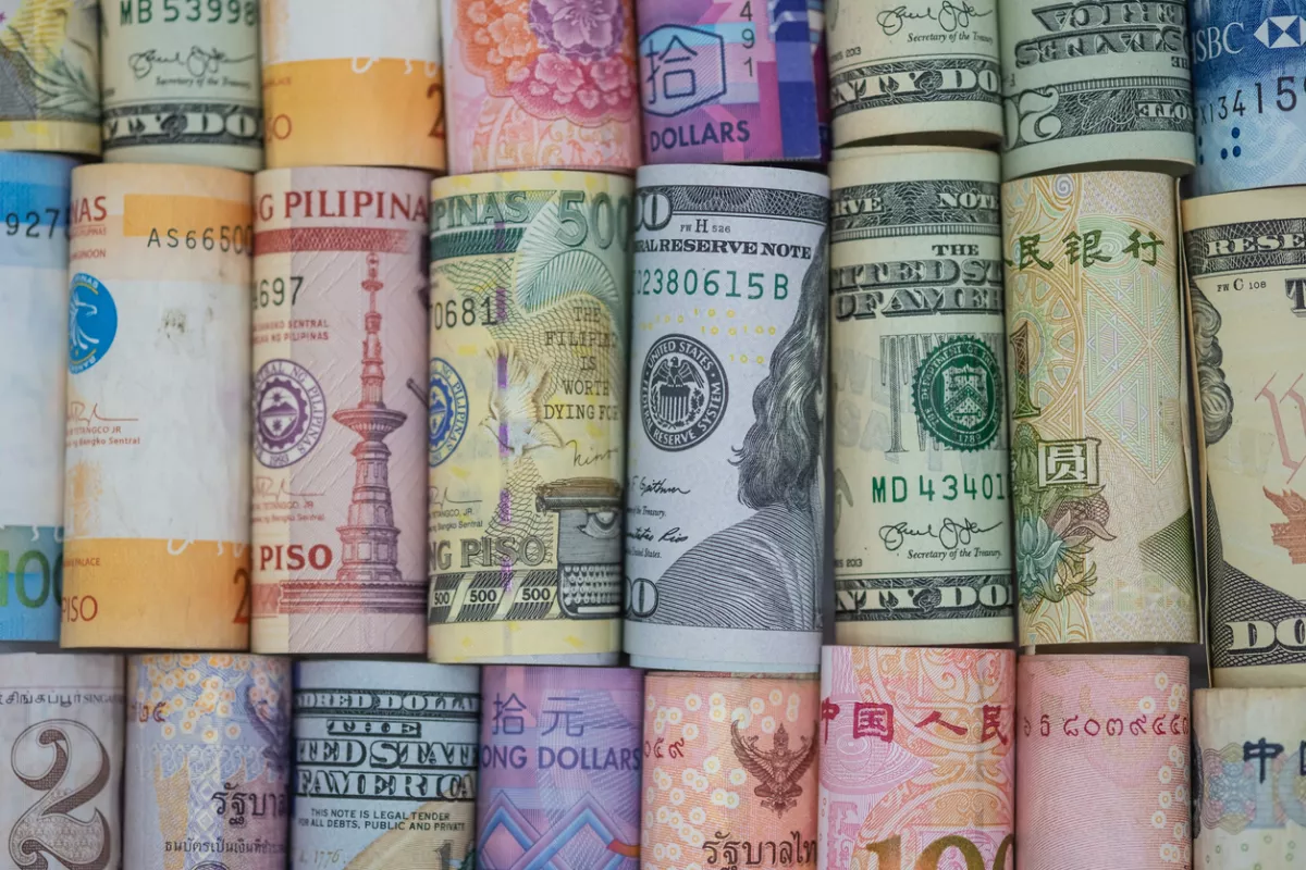 Closeup rolled of variety banknote around the world. Exchange rate and Forex investment concept.-Image.