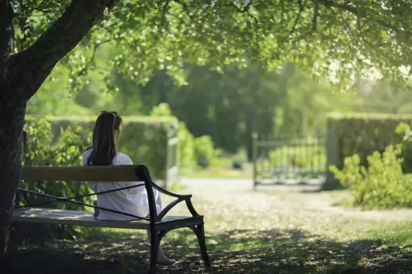 A woman relaxing in a green garden