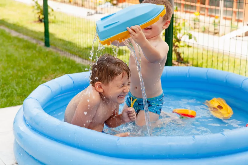 Two,Children,With,Toys,At,Swimming,Pool.,Joyful,Kid,Playing