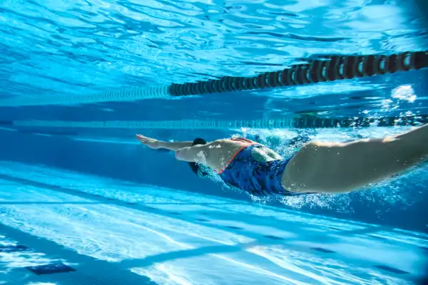 Adaptive Athlete diving into the swimming pool.