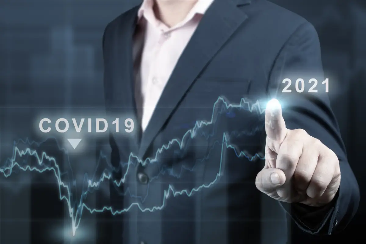 concept of economic recovery after the fall due to the covid 19 coronavirus pandemic. Financial graph 2021. Stock market chart. Businessman pointing graph. Return of growth after a fall