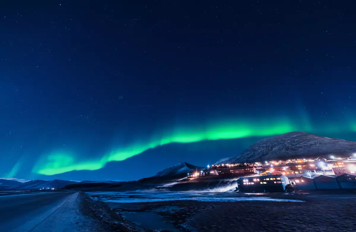 The polar arctic Northern lights aurora borealis sky star in Norway Svalbard in Longyearbyen city the moon mountains