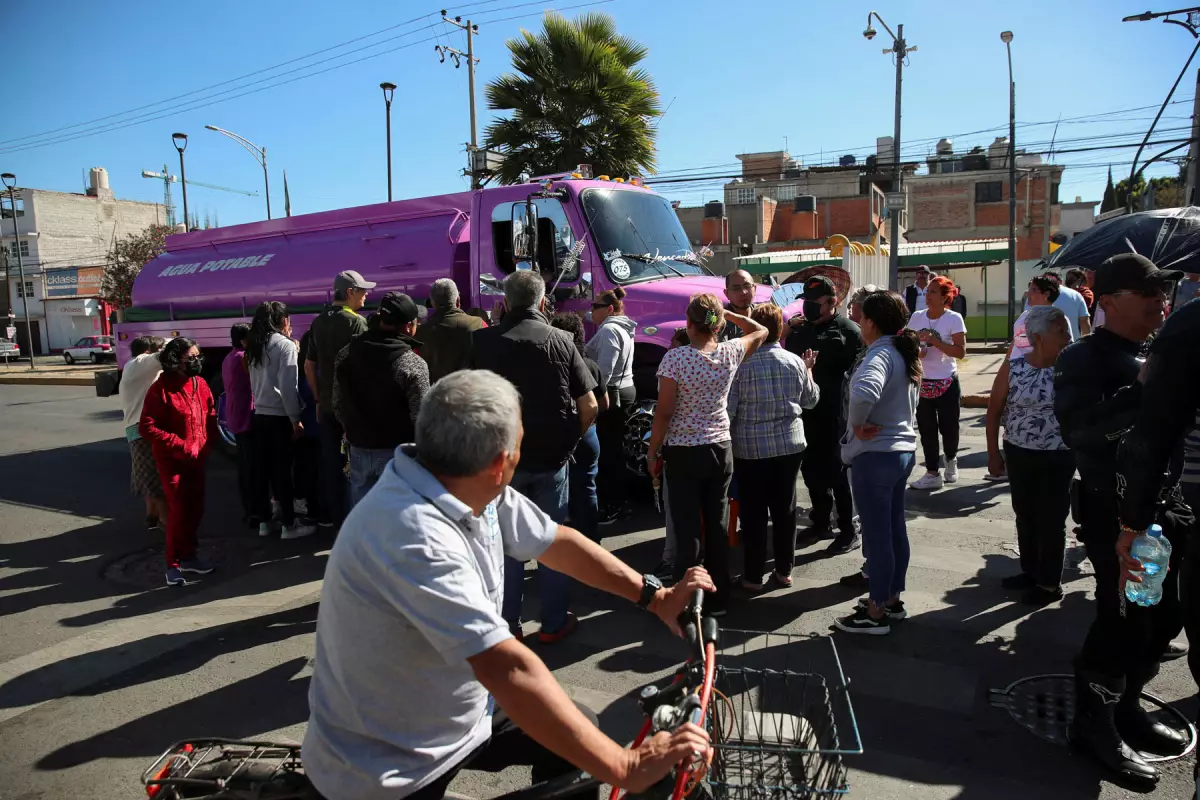 Residents gather near a water tanker truck in Mexico City