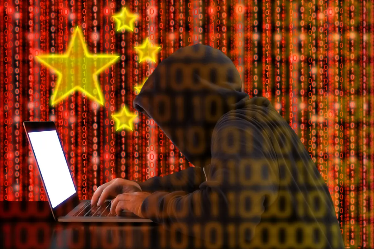 Chinese hacker at work in front of red flag