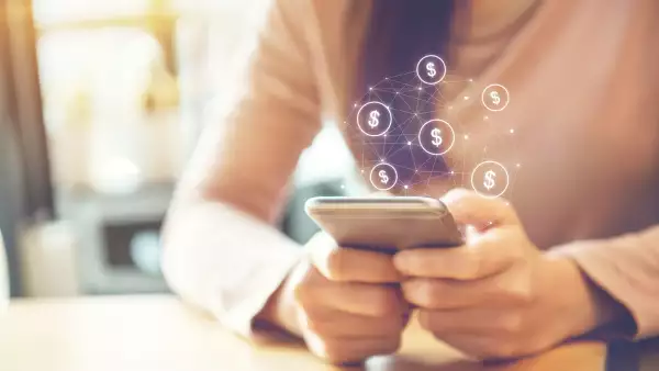 Female Hand using mobile smartphone with dollar icon