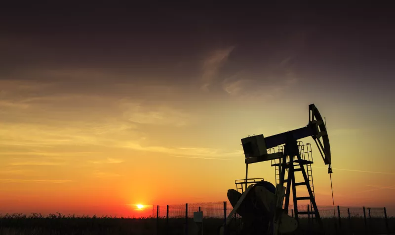 An oil and gas well operating during sunset
