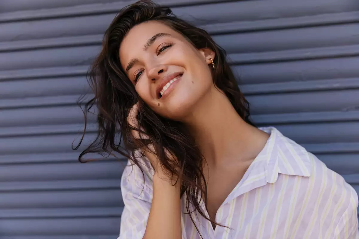 Pretty,Young,Caucasian,Woman,Looking,Into,Distance,Smiling,Corrects,Her