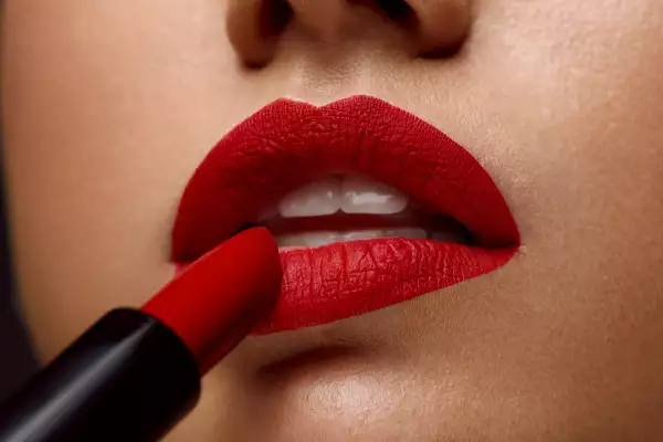 Red Lipstick. Closeup Of Woman Face With Bright Lips Makeup