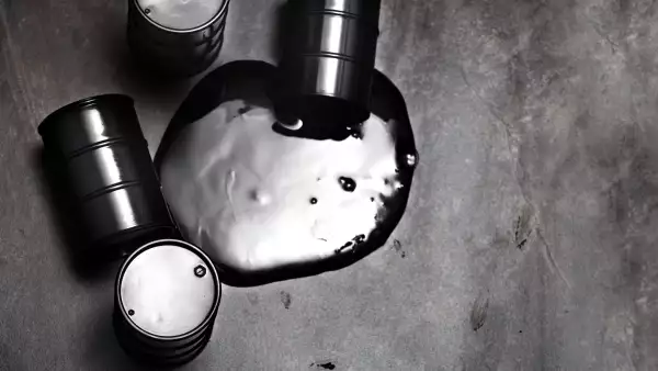 High angle view on four fuel barrels with spilled oil