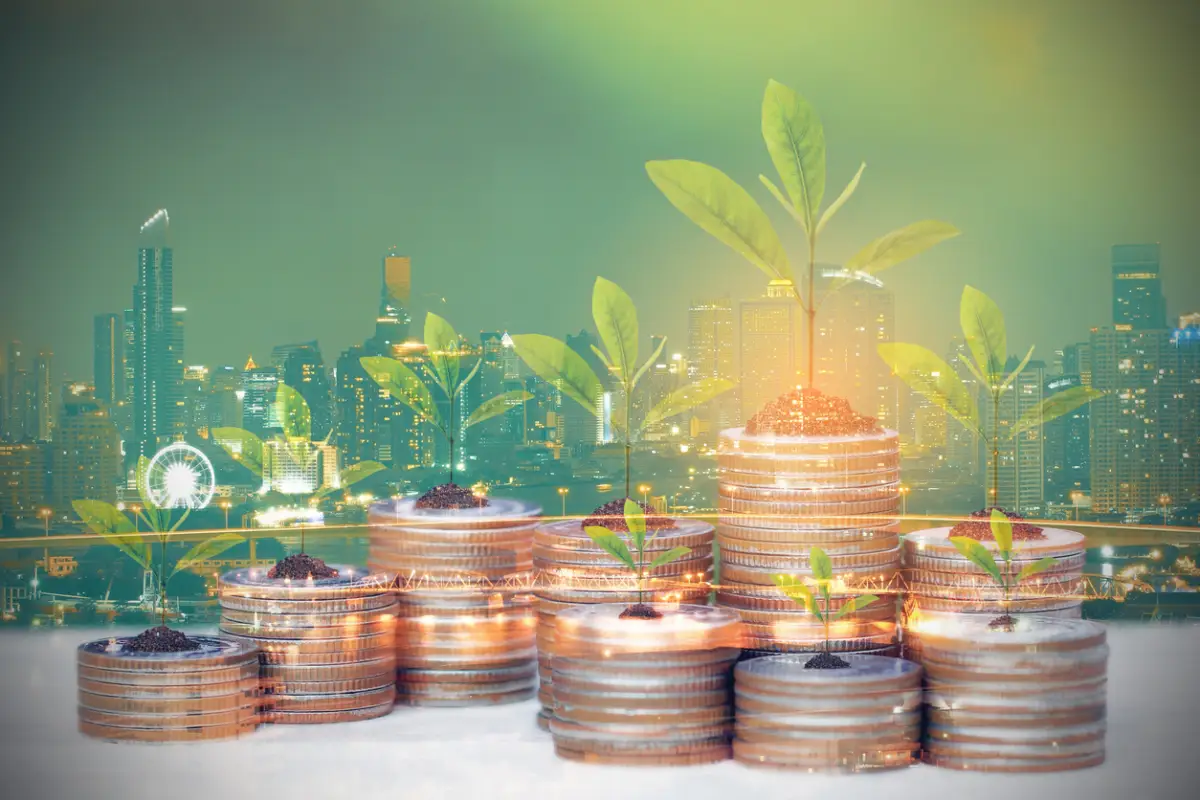 Double exposure of Trees growing on coins money on city background for Real estate investments and business concept