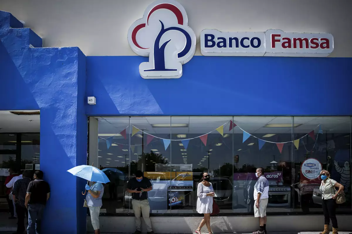 People queue to enter to a branch of Banco Ahorro Famsa, the savings bank arm of retailer Grupo Famsa, in Ciudad Juarez