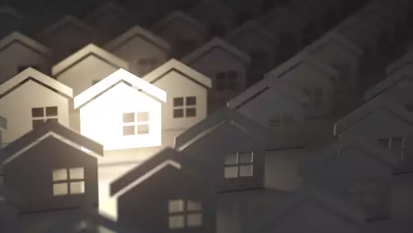 Unique lighting house sign in group of  houses. Real estate property industry concept background.