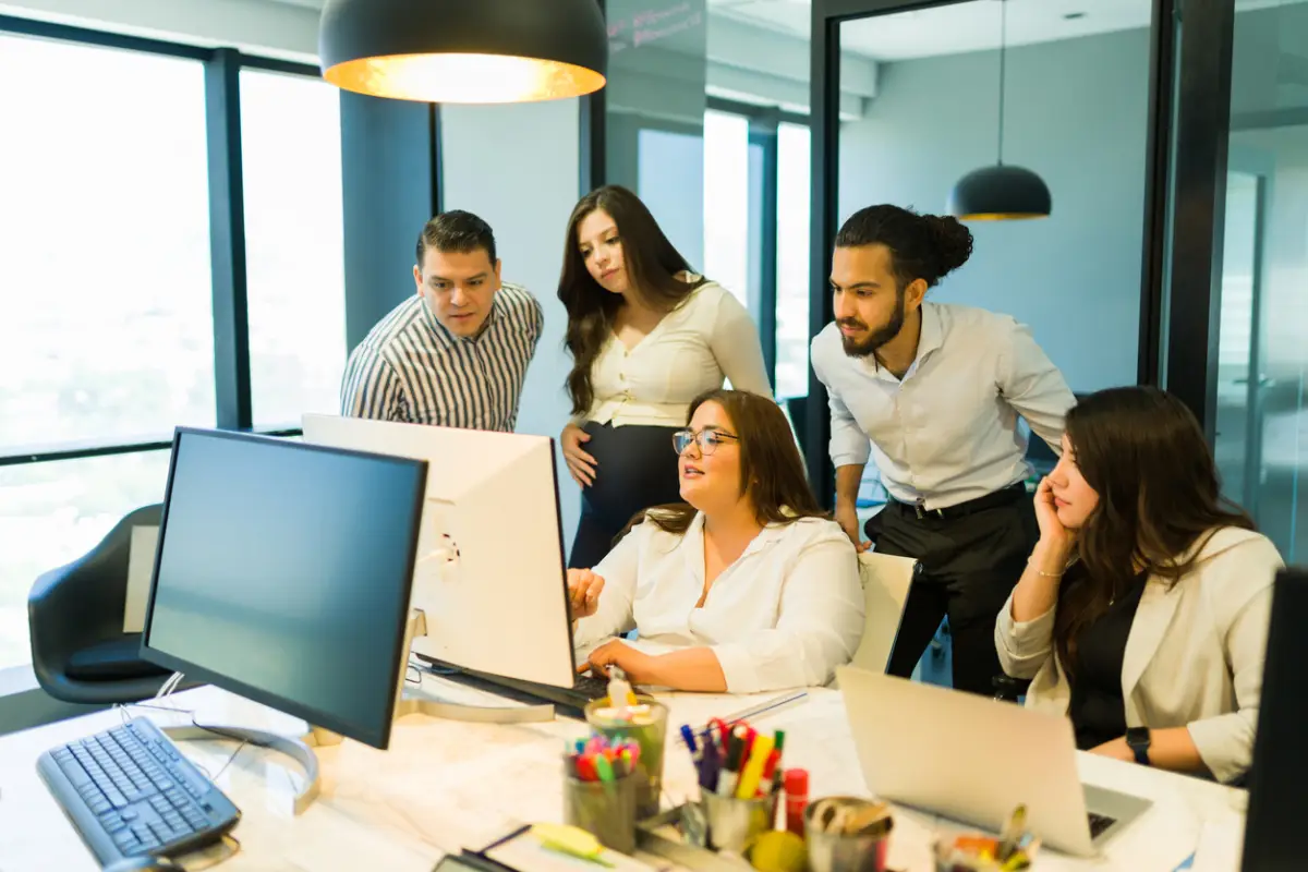 Plus size businesswoman sharing project details with team in office