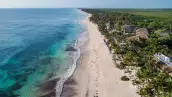 Top view aerial photo from flying drone of an amazingly beautiful sea landscape. Sea Aerial view, Top view. Tulum Beach, Mexico. Sea Aerial view. Amazing nature background. The color of the water and beautifully bright. Azure beach.