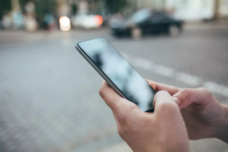 Woman's hands holding smart phone