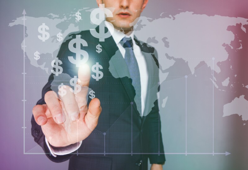 Businessman touching dollar signs on virtual screen