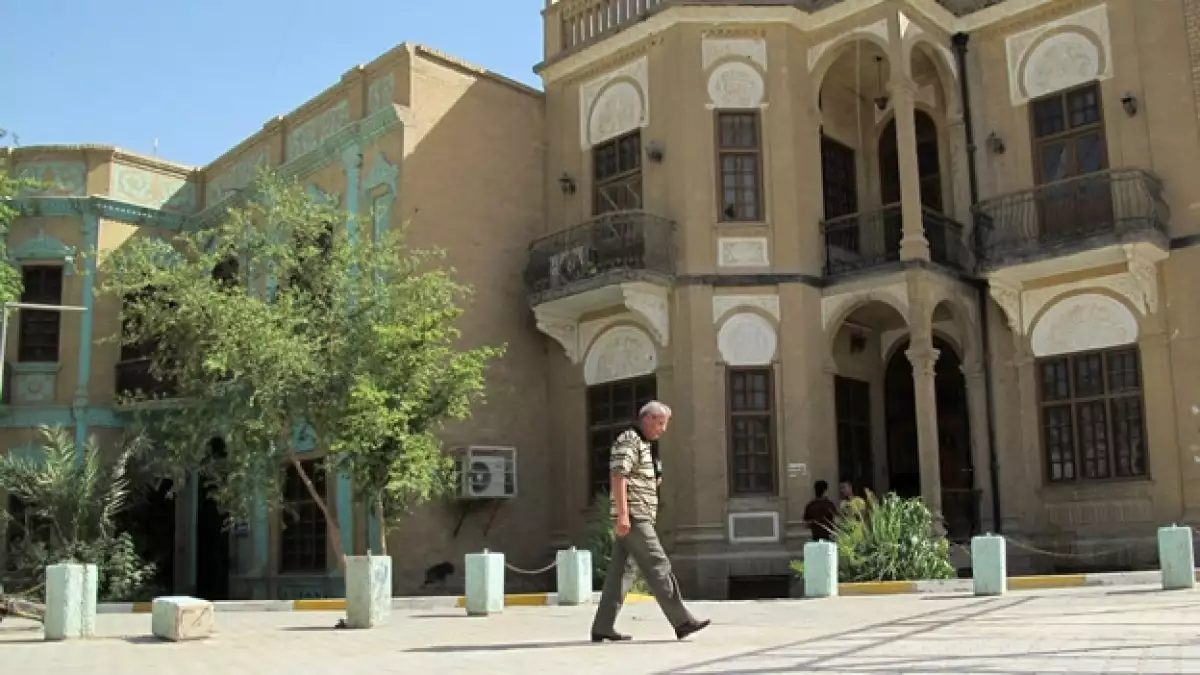 un hombre pasa ante un edificio de piedra